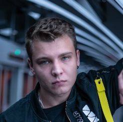 Young man with serious expression in industrial setting